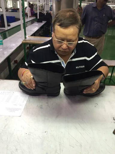 Inspector reviewing finished shoe